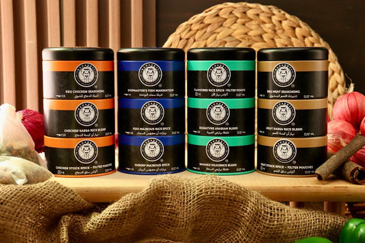 Four cylindrical containers with labels on a wooden surface with decorative elements.